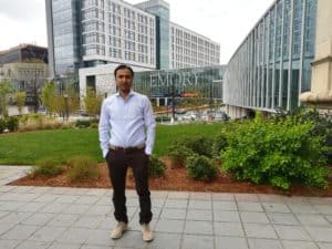 Dr. Nasir International Career Development Exchange standing in front of buildings.